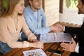 Real estate agent and clients shaking hands after signing property agreement Royalty Free Stock Photo