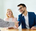 young couple shaking hands deal contract real estate investment business agreement agent handshake signing Royalty Free Stock Photo