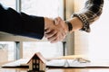 Real estate agent and customers shaking hands together celebrating finished contract after about home insurance and Royalty Free Stock Photo
