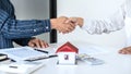 Real estate agent and customers shaking hands together celebrating finished contract after signing about home insurance and Royalty Free Stock Photo