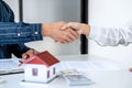 Real estate agent and customers shaking hands together celebrating finished contract after signing about home insurance and Royalty Free Stock Photo