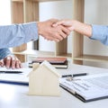 Real estate agent and customers shaking hands together celebrating finished contract after signing about home insurance and Royalty Free Stock Photo