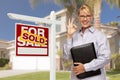 Real Estate Agent in Front of Sold Sign and House Royalty Free Stock Photo