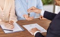 Real estate agent giving house key to young couple after signing property agreement at table, close up Royalty Free Stock Photo