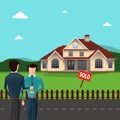 Real estate agent giving house keys to his client in front of the sold house. Royalty Free Stock Photo
