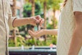 Real estate agent giving keys to apartment owner, buying selling property business. Close up of male hand taking house