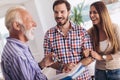 Real estate agent giving keys to couple of customers Royalty Free Stock Photo