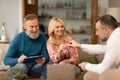 Real Estate Agent Giving New House Keys To Couple Indoors Royalty Free Stock Photo