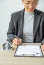 real estate agent hand holding pen and explains the business contract, rent, purchase, mortgage, a loan, or home insurance to Royalty Free Stock Photo