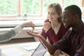 Real estate agent handing house keys to happy multiethnic couple