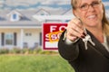 Real Estate Agent Handing Over New House Keys with Sold Sign Behind Royalty Free Stock Photo