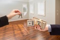 Real Estate Agent Hands Over New House Keys For Cash Inside Empty Room Royalty Free Stock Photo