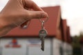 Real estate agent holding keys to new house outdoors, closeup Royalty Free Stock Photo