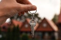 Real estate agent holding keys to new house outdoors, closeup Royalty Free Stock Photo