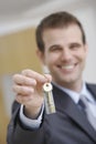 Real Estate Agent Holding Out House Key Royalty Free Stock Photo