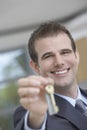 Real Estate Agent Holding Out House Key Royalty Free Stock Photo