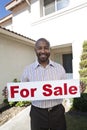 Real Estate Agent Holding 'For Sale' Sign Royalty Free Stock Photo