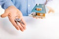 Real estate agent with house model and keys in hands Royalty Free Stock Photo