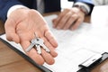 Real estate agent with keys at table in office Royalty Free Stock Photo