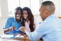 Real estate agent presenting contract to african american couple Royalty Free Stock Photo