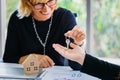 Real estate agent putting keys on crop hand