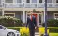 Real estate. Agent ready to sell home. Businessman standing outside a modern house. Royalty Free Stock Photo