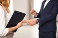 Real estate agent shaking hands with client in office, closeup