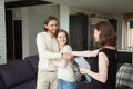 Real estate agent shaking hands couple clients in rental house Royalty Free Stock Photo