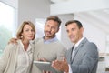 Real-estate agent showing couple their new appartment Royalty Free Stock Photo