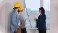 A real estate agent showing a layout to a young married couple Royalty Free Stock Photo