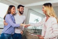 Real Estate agent shows interior to couple