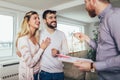 Real Estate agent shows interior to couple