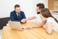 Real estate agent shows a young couple a new home. family buys housing Royalty Free Stock Photo