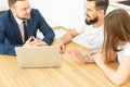 Real estate agent shows a young couple a new home. family buys housing Royalty Free Stock Photo