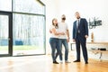 Real estate agent shows a young couple a new home. family buys housing Royalty Free Stock Photo