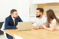 Real estate agent shows a young couple a new home. family buys housing Royalty Free Stock Photo