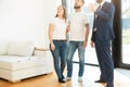 Real estate agent shows a young couple a new home. family buys housing Royalty Free Stock Photo
