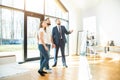 Real estate agent shows a young couple a new home. family buys housing Royalty Free Stock Photo