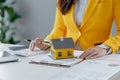 A real estate agent sits in her office, The salesperson is presenting what the home the customer is about to buy looks like, The Royalty Free Stock Photo