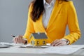 A real estate agent sits in her office, The salesperson is presenting what the home the customer is about to buy looks like, The Royalty Free Stock Photo