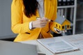 A real estate agent sits in her office, The salesperson is presenting what the home the customer is about to buy looks like, The Royalty Free Stock Photo