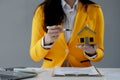 A real estate agent sits in her office, The salesperson is presenting what the home the customer is about to buy looks like, The Royalty Free Stock Photo