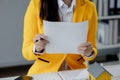 A real estate agent sits in her office, The salesperson is presenting what the home the customer is about to buy looks like, The Royalty Free Stock Photo