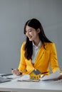 A real estate agent sits in her office, The salesperson is presenting what the home the customer is about to buy looks like, The Royalty Free Stock Photo