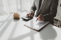 A real estate agent sits in her office, The salesperson is presenting what the home the customer is about to buy looks like, The Royalty Free Stock Photo