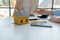 A real estate agent sits in her office, The salesperson is presenting what the home the customer is about to buy looks like, The Royalty Free Stock Photo