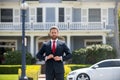 Real estate agent welcoming visitors near new house. Portrait of realtor man. Royalty Free Stock Photo