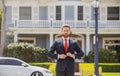 Real estate agent welcoming visitors near new house. Portrait of realtor man. Royalty Free Stock Photo