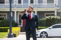 Real estate agent welcoming visitors near new house. Portrait of realtor man. Royalty Free Stock Photo