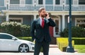 Real estate agent welcoming visitors near new house. Portrait of realtor man. Royalty Free Stock Photo